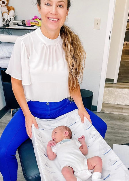 Dr. Jessica Caceres with a newborn at the practice